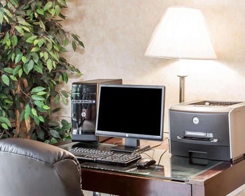 a computer and printer on a desk with a lamp at Econo Lodge Newport West in Newport