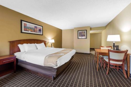 a hotel room with a large bed and a desk at Quality Inn & Suites Sevierville - Pigeon Forge in Sevierville
