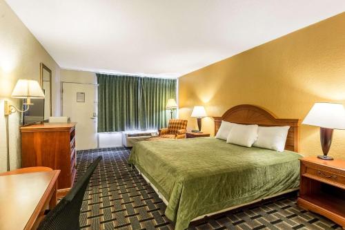 a hotel room with a bed and a living room at Rodeway Inn Denmark-Jackson in Denmark