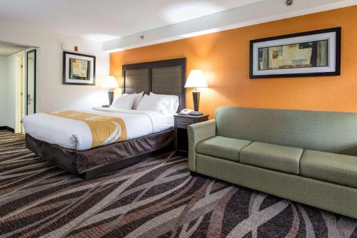 a hotel room with a bed and a couch at Quality Inn Creekside - Downtown Gatlinburg in Gatlinburg