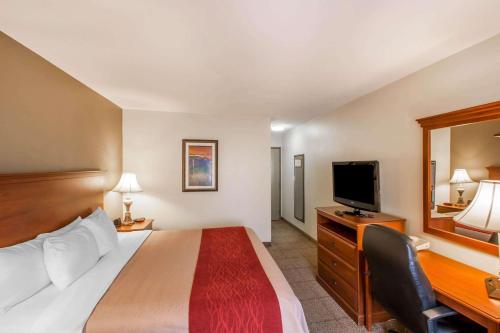 a hotel room with a bed and a flat screen tv at Quality Inn & Suites Germantown North in Memphis