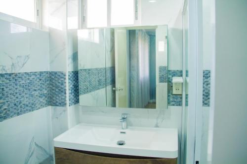 a bathroom with a sink and a mirror at Pearl of Santa Fe - Sabal's Lodge in Bantayan Island