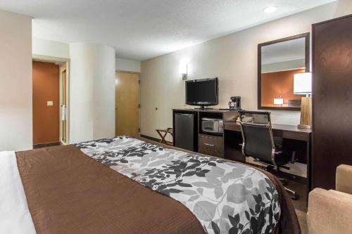 a hotel room with a bed and a desk and a television at Sleep Inn Nashville near Percy Priest Lake in Nashville