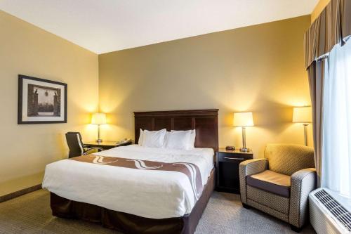 a hotel room with a bed and a chair at Quality Inn Union City US 51 in Union City
