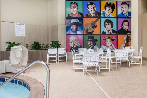 a room with tables and chairs and a large wall of pictures at Holiday Inn Nashville Downtown - Stadium by IHG in Nashville