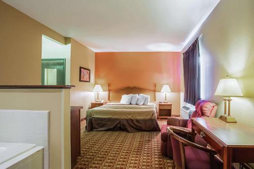 a hotel room with a bed and a couch at Econo Lodge Inn & Suites in Ripley