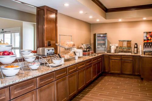a large kitchen with a counter with food on it at Comfort Suites New Braunfels - San Antonio Area in New Braunfels