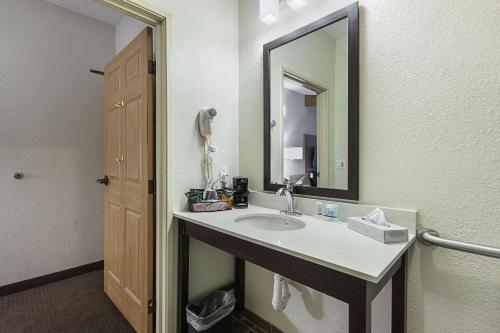 a bathroom with a sink and a mirror at Sleep Inn University in El Paso