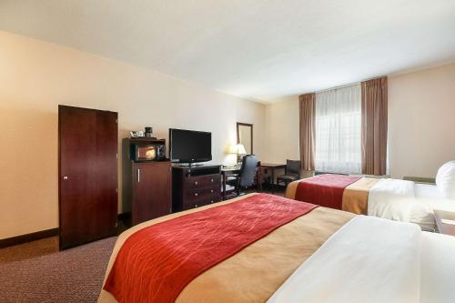a hotel room with two beds and a television at Quality Inn Kingsville Hwy 77 in Kingsville
