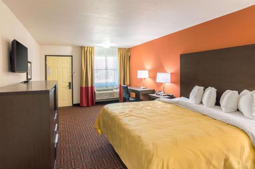 a hotel room with a bed and a television at Quality Inn East Amarillo in Amarillo