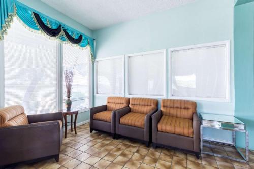 a living room with two couches and windows at HillView Inn at Six Flags Fiesta in San Antonio