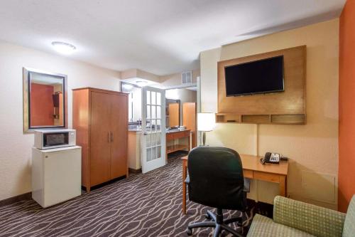 a hotel room with a desk and a computer and a room at Quality Inn & Suites I-35 near Frost Bank Center in San Antonio