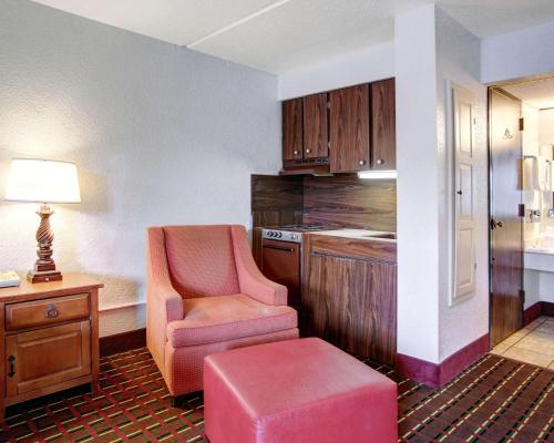 a living room with a chair and a table at Rodeway Inn New Braunfels - San Antonio Area in New Braunfels