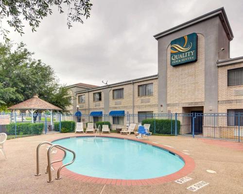 a swimming pool in front of a building at Quality Inn & Suites Grand Prairie South in Grand Prairie