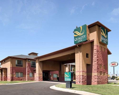 a front view of a hotel with a sign at Quality Inn Midland South in Midland