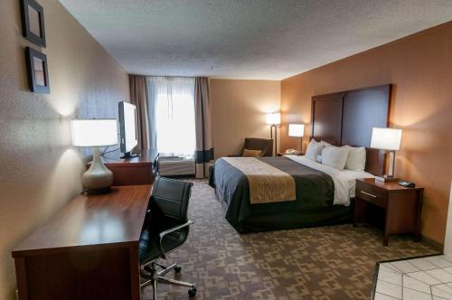 a hotel room with a bed and a desk at Comfort Inn North Conroe in Conroe