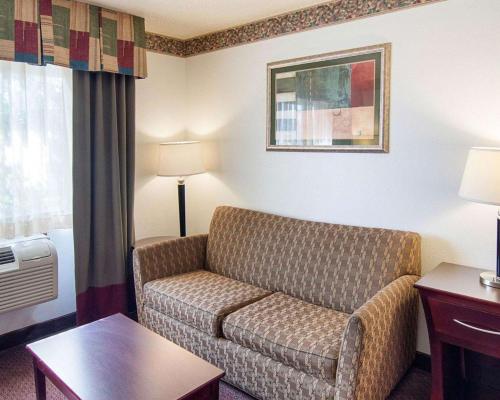 a living room with a couch in a hotel room at Quality Inn Midland South in Midland