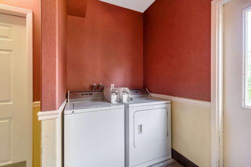 a washer and dryer in a corner of a room at Quality Suites North Houston - Spring in Houston