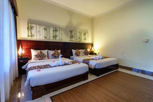 En eller flere senge i et værelse på Segara Anak Hotel