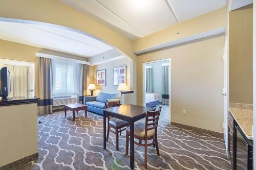 a living room with a table in a hotel room at Comfort Suites Beachside in South Padre Island