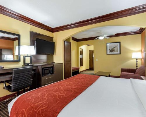 a hotel room with a bed and a desk at Comfort Suites Lake Jackson Clute in Lake Jackson