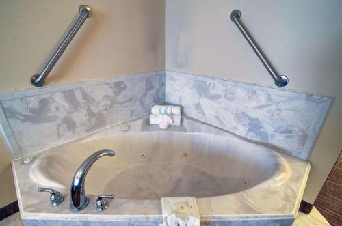 a bath tub with a faucet in a bathroom at Comfort Inn & Suites in Amarillo