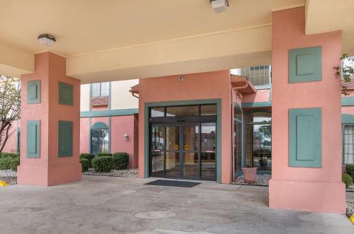 a building with a large glass door in front of it at Quality Suites in Temple