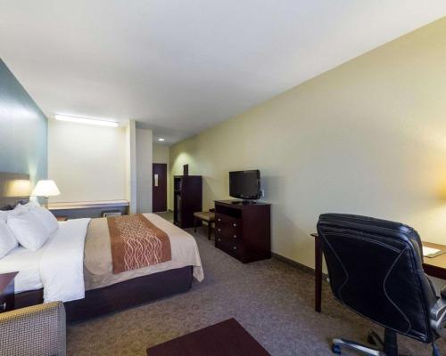 a hotel room with a bed and a tv at Quality Inn Ingleside - Corpus Christi in Ingleside