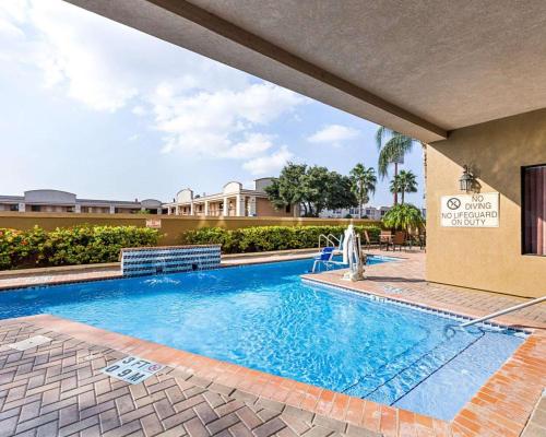 a swimming pool in front of a building at Comfort Suites At Plaza Mall in McAllen