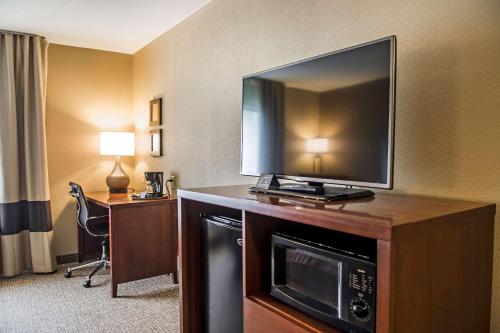 a hotel room with a flat screen tv on a table at Comfort Inn Edinburg South in Edinburg