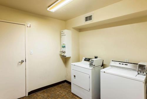 a laundry room with a washer and dryer at Quality Inn Near Seaworld - Lackland in San Antonio