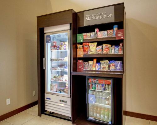 a refrigerator with its door open with food inside at Comfort Suites Tyler South in Tyler