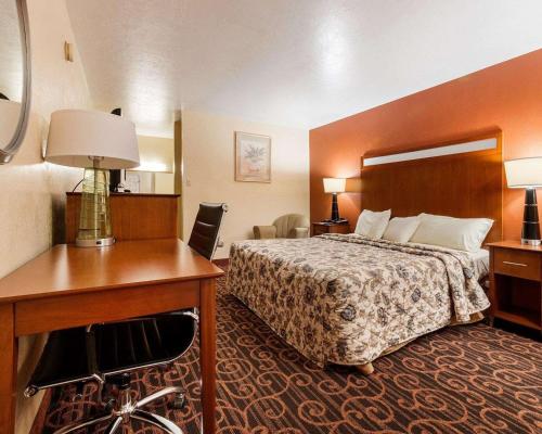 a hotel room with a bed and a desk at Econo Lodge Jasper in Jasper