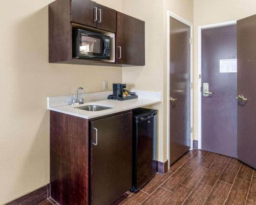 a kitchen with a sink and a microwave at Comfort Suites Odessa near University in Odessa