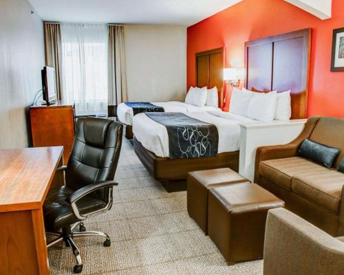 a hotel room with two beds and a desk at Comfort Suites Tyler South in Tyler