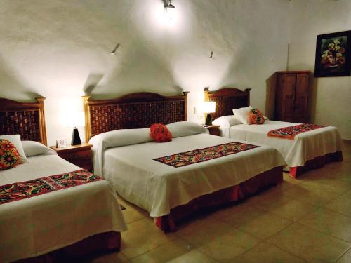 Postel nebo postele na pokoji v ubytování Hotel Real Colonial