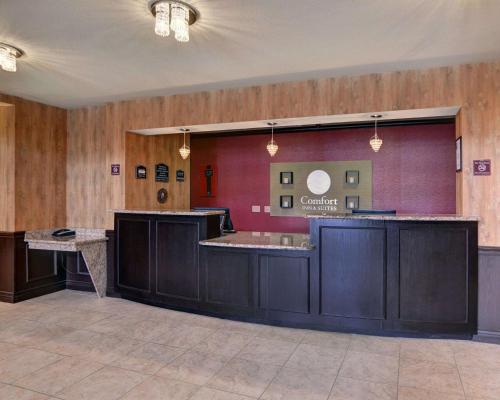 a large lobby with a counter in a room at Comfort Inn & Suites Near Lake Lewisville in Corinth