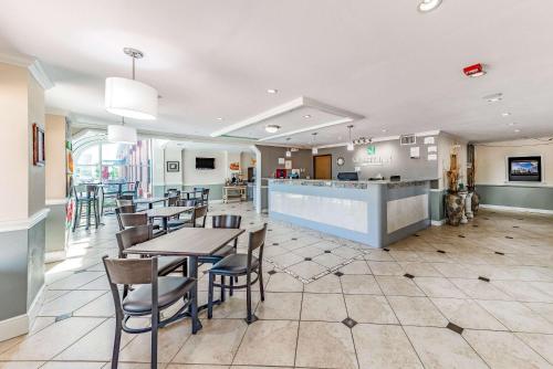 a restaurant with tables and chairs and a bar at Quality Inn Allen - Plano East in Allen