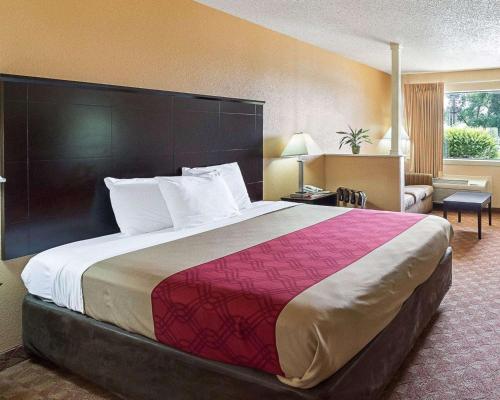 a large bed in a hotel room at Econo Lodge Inn & Suites Downtown Northeast near Ft Sam Houston, AT&T in San Antonio