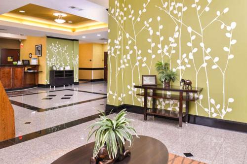an office lobby with a flower mural on the wall at Sleep Inn and Suites Downtown Houston in Houston