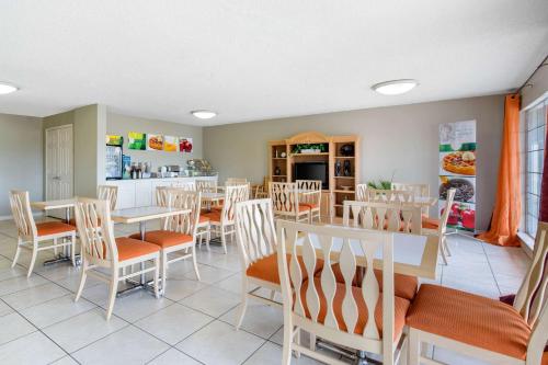 a restaurant with tables and chairs and a kitchen at Quality Inn Clute Freeport in Clute