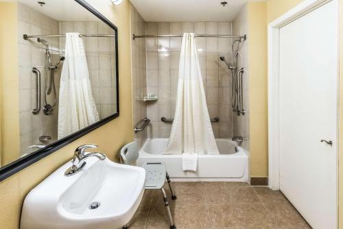 a bathroom with a sink and a bath tub at Quality Inn in Corsicana
