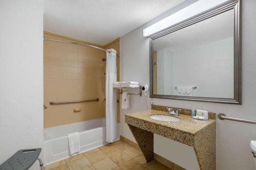 a bathroom with a sink and a mirror at Quality Inn Clute Freeport in Clute
