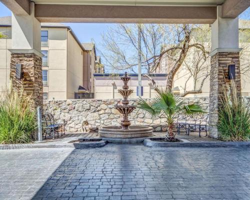 a courtyard with a fountain and a stone wall at Comfort Inn & Suites El Paso I-10 Airport Area in El Paso
