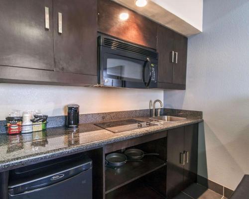 a kitchen with a sink and a microwave at Comfort Inn & Suites El Paso I-10 Airport Area in El Paso