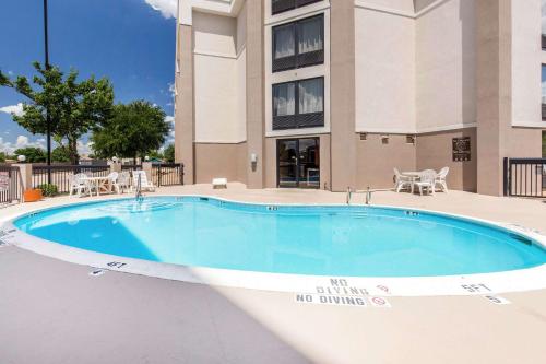 a swimming pool with a no drinking sign next to a building at Comfort Inn Wichita Falls North in Wichita Falls