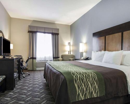 a hotel room with a large bed and a desk at Comfort Inn & Suites El Paso I-10 Airport Area in El Paso