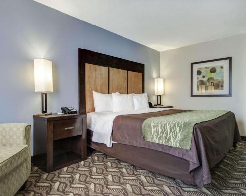 a hotel room with a bed and a couch at Comfort Inn & Suites I-10 Airport in El Paso