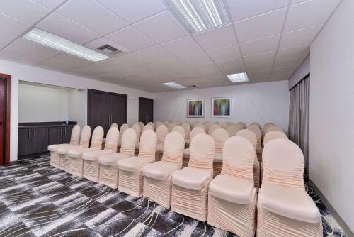 a conference room with white chairs in it at Comfort Inn & Suites Frisco - Plano in Frisco
