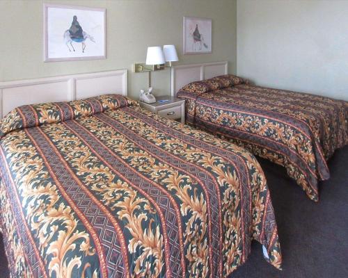 a hotel room with two beds in a room at Rodeway Inn in San Juan